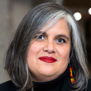 Woman's headshot smiling looking at camera.
